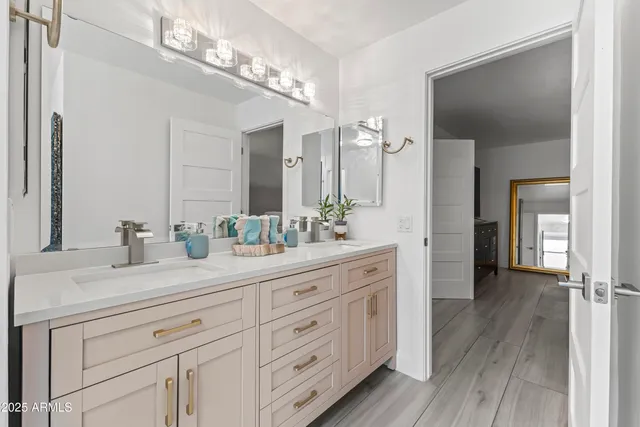 a spacious bathroom with a double vanity sink double and mirror