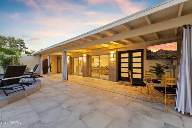 a spacious bedroom with a large bed and a large window