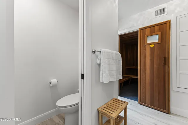 a bathroom with a toilet and a shower