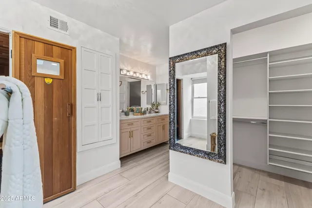 a kitchen with a refrigerator and white cabinets
