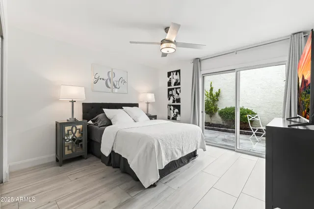 a bedroom with a large bed and a large window