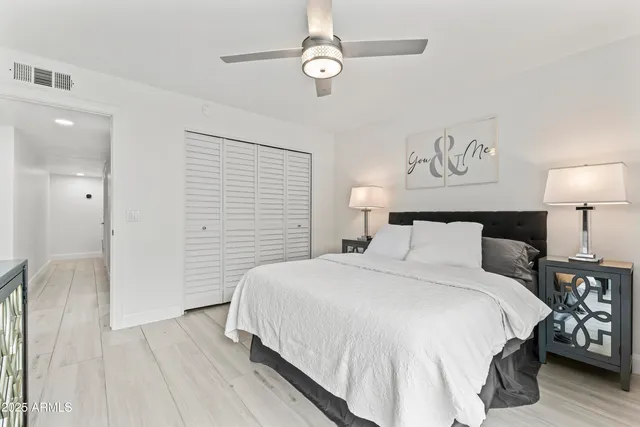 a bedroom with a bed and a table