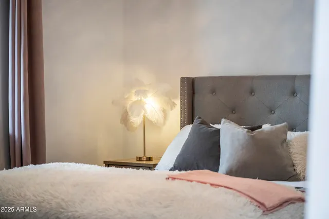 a bedroom with a bed and a night stand