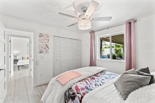 a bedroom with a large bed and a chandelier