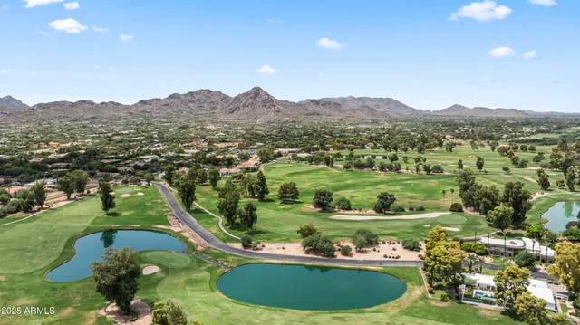 a view of a lush green hillside and houses