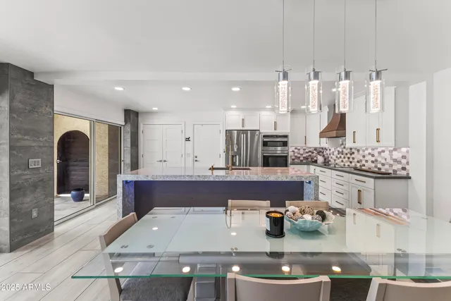 a large living room with stainless steel appliances kitchen island granite countertop furniture and a view of living room