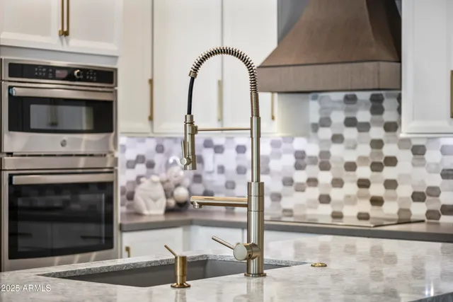 a kitchen with granite countertop a stove and a microwave
