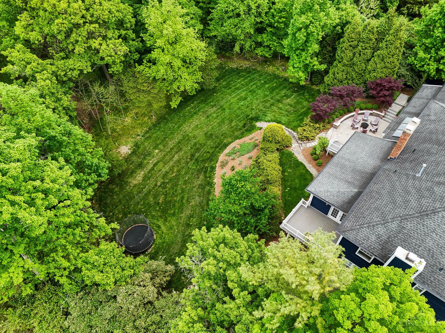 2780 Walsh Road Cincinnati, OH 45208 - Photo 60 of 68 Set on a private, tree-lined 1.5-acre lot, this exceptional residence offers a rare combination of space, seclusion and refined living. With generously scaled rooms, multiple indoor and outdoor gathering areas and a flexible layout designed to accommodate a variety of lifestyles, the home lives as beautifully as it entertains. From the expansive main level to the thoughtfully finished lower level and serene outdoor spaces, every detail contributes to a sense of comfort and ease. All of this is ideally positioned in a coveted Hyde Park location, offering both privacy and convenience with easy access to nearby amenities—creating a truly special place to call home.