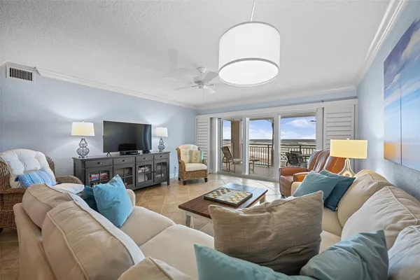 a living room with furniture a large window and a flat screen tv