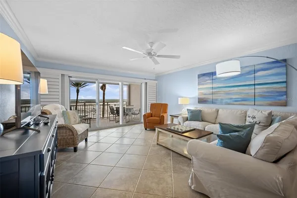 a living room with furniture and a floor to ceiling window