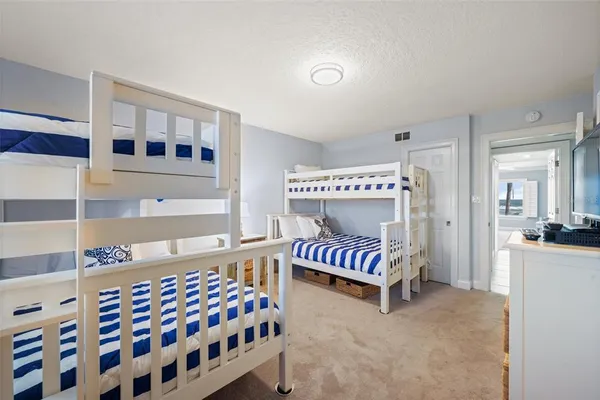 a bedroom with furniture and a baby crib