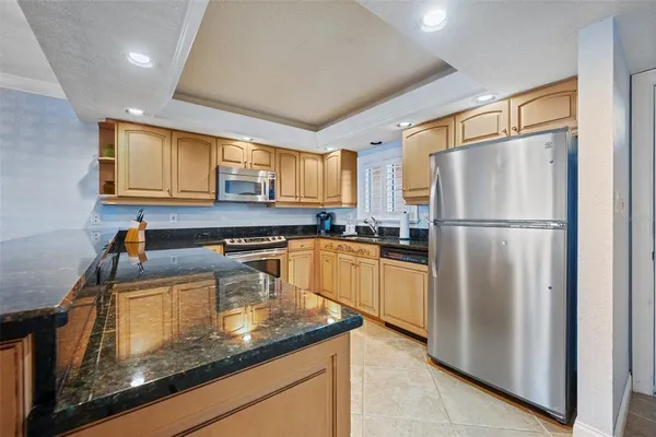 a kitchen with a refrigerator a sink and cabinets