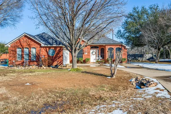 a view of a yard with a house in the background