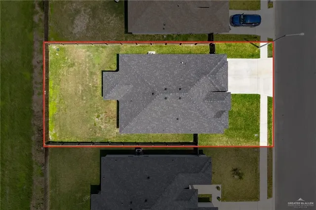 an aerial view of a residential houses with outdoor space
