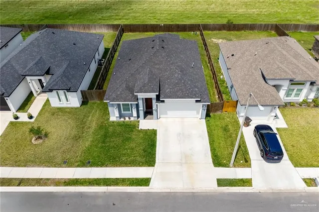 an aerial view of residential houses with outdoor space and swimming pool