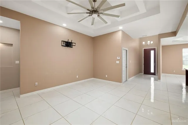 a view of a hallway with a chandelier fan