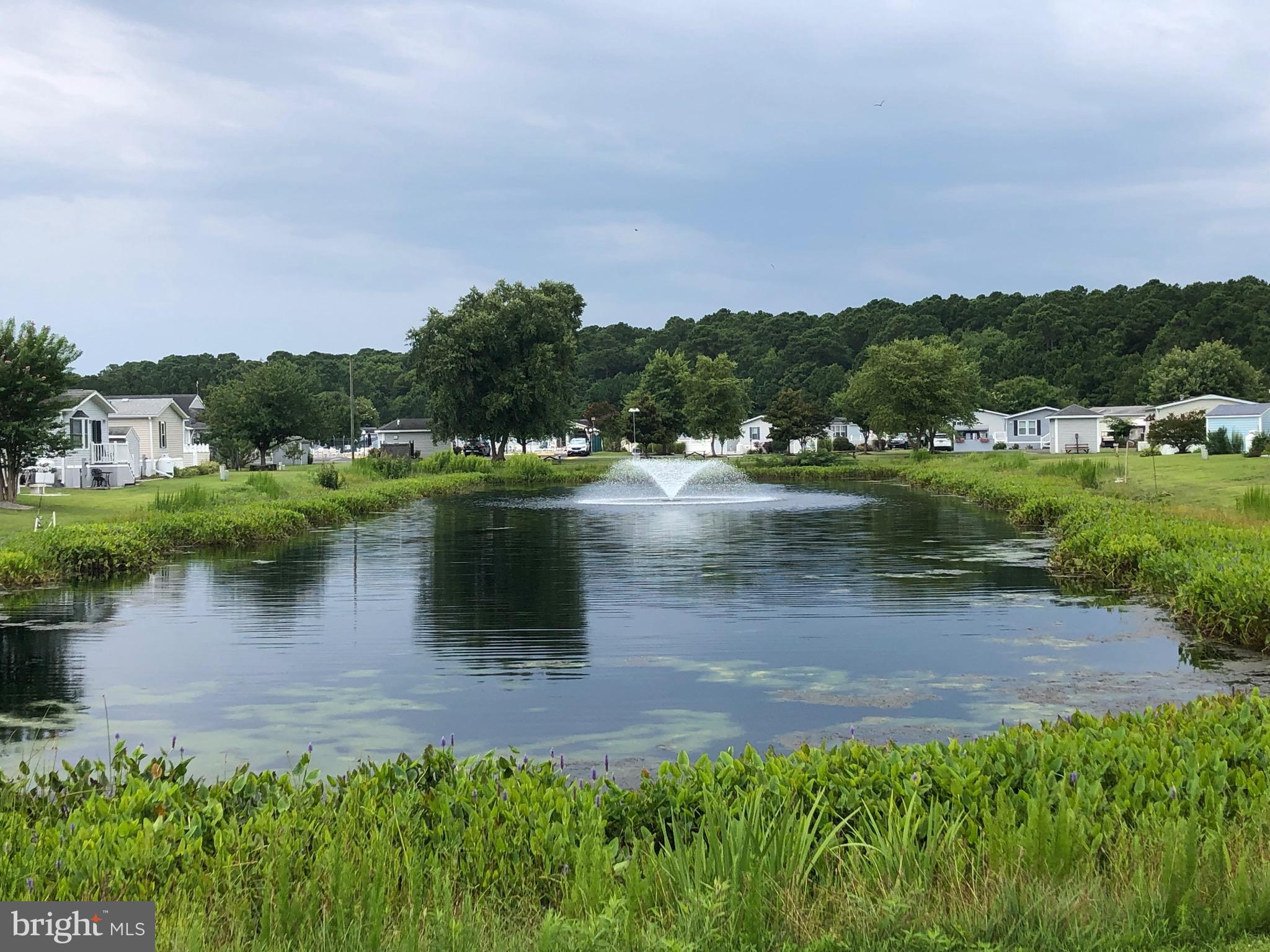 12020 Assateague Way Berlin, MD 21811 - Photo 24 of 110 a view of a lake with houses in back