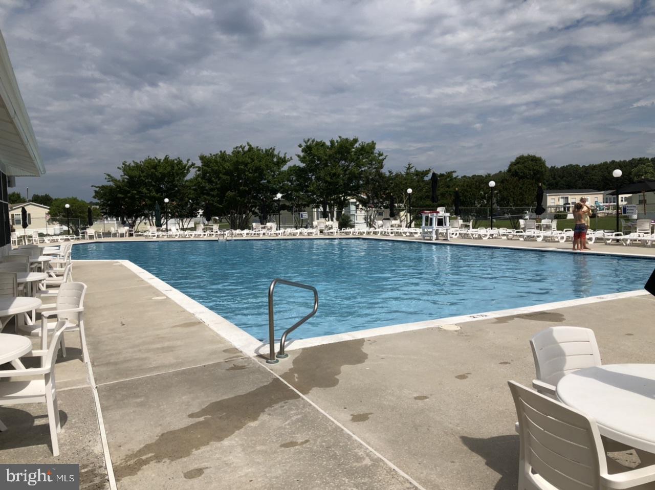 12020 Assateague Way Berlin, MD 21811 - Photo 38 of 110 a view of a swimming pool with an outdoor seating and lake view