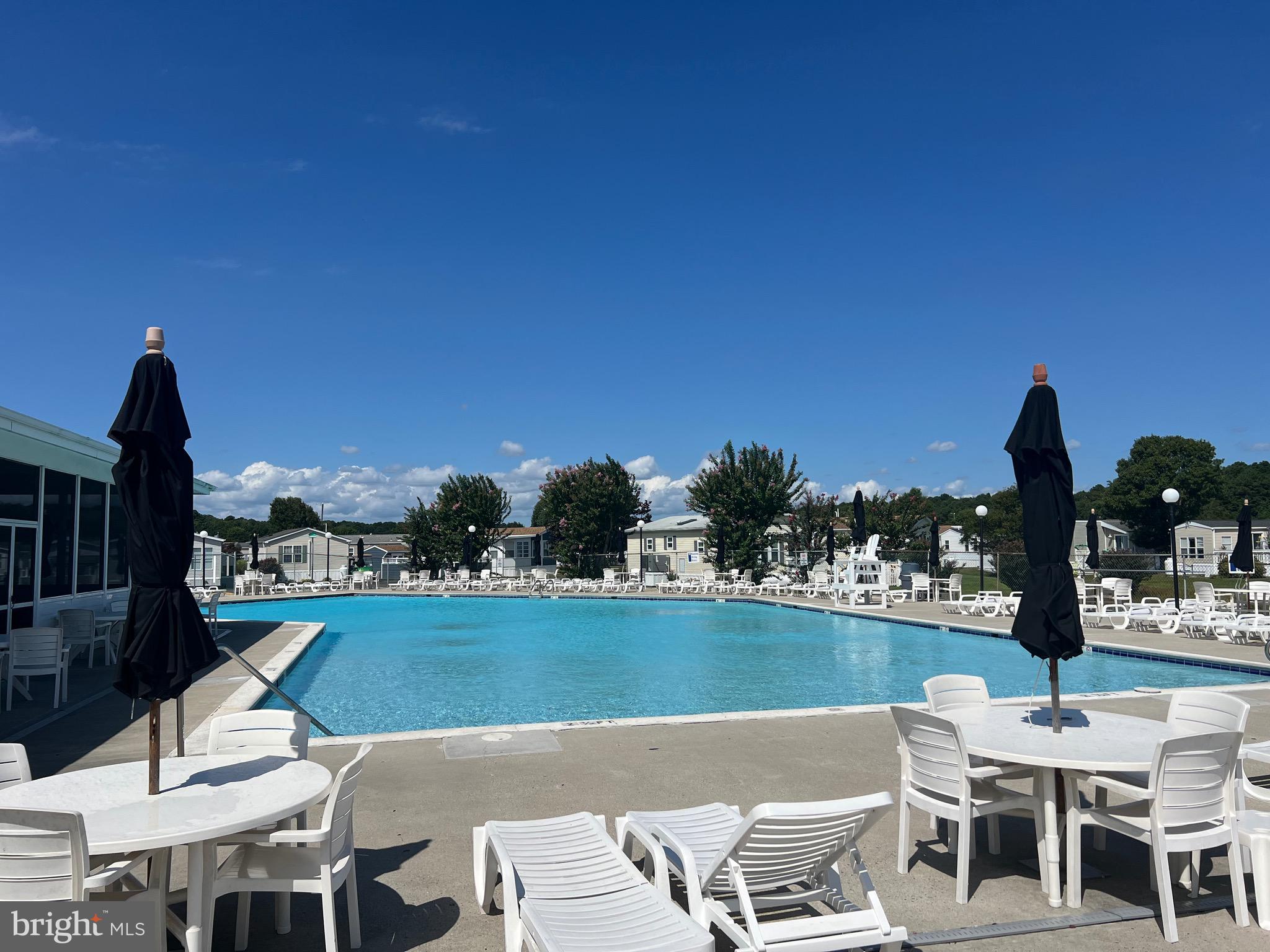 12020 Assateague Way Berlin, MD 21811 - Photo 39 of 110 a view of swimming pool with outdoor seating and city view