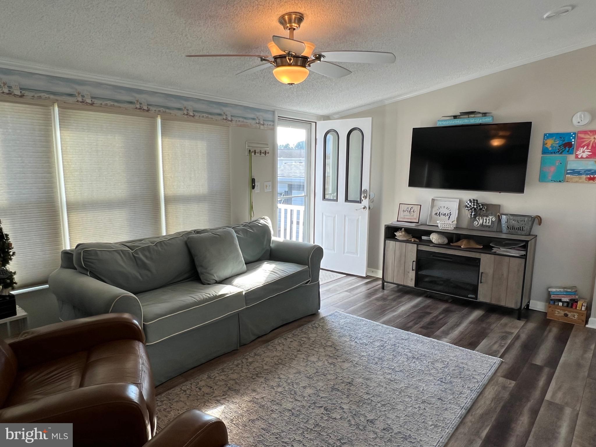 12020 Assateague Way Berlin, MD 21811 - Photo 5 of 110 a living room with furniture and a flat screen tv