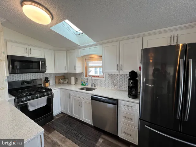 a view of a dining room with furniture and a chandelier