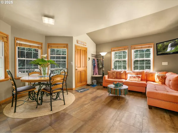 a living room with furniture and floor to ceiling windows