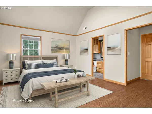 a bedroom with a bed and wooden floor