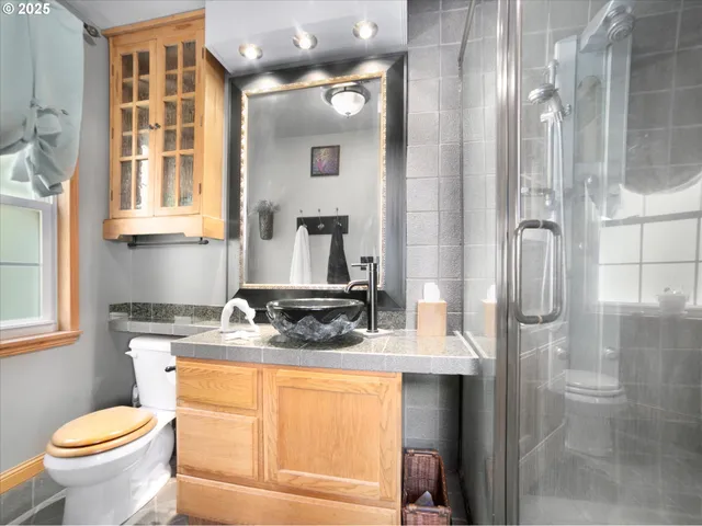 a bathroom with a granite countertop sink toilet and shower