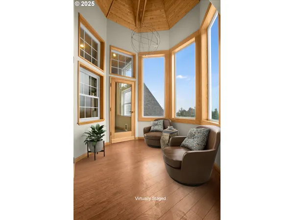 a living room with furniture and floor to ceiling windows