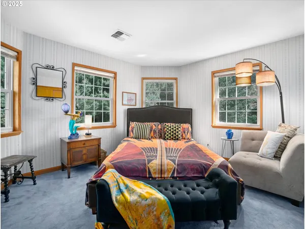 a bedroom with furniture and a window