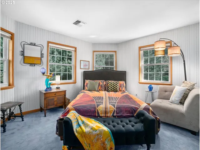 a bedroom with furniture and a window