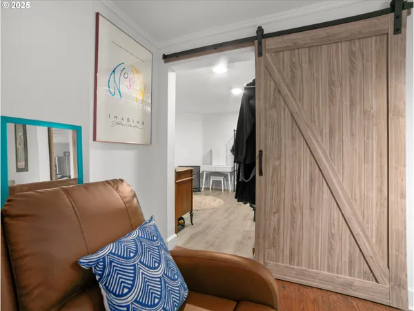 a living room with furniture a couch and wooden floor