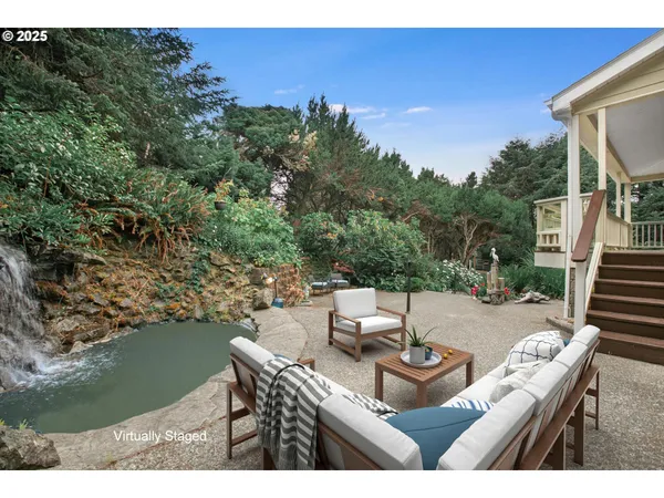 a view of a patio with table and chairs with wooden floor and fence