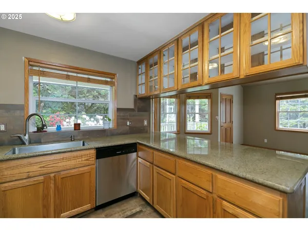 a kitchen with cabinets and window