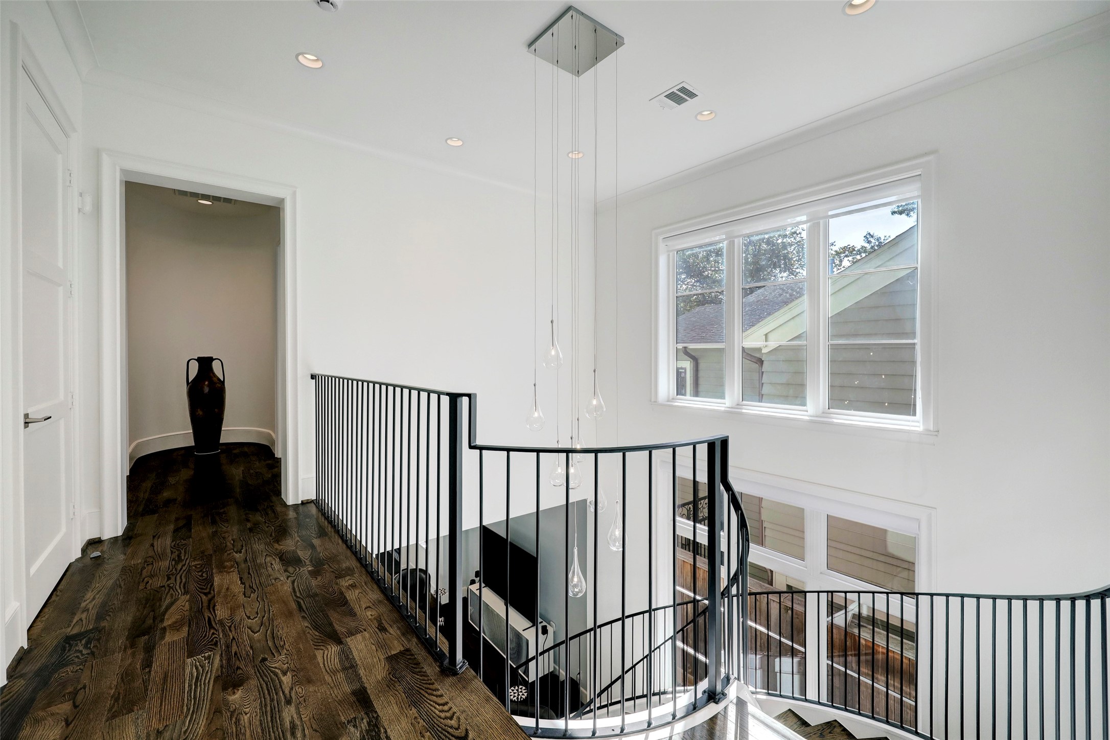 2501 Yupon Street Houston, TX 77006 - Photo 20 of 48 a view of a hallway with wooden floor and staircase