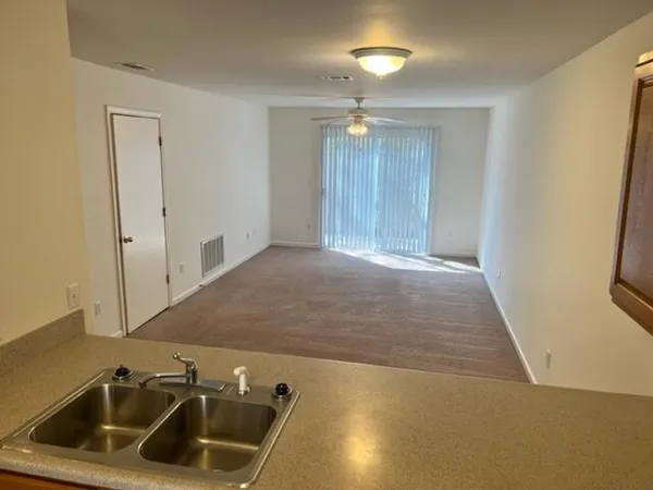 a view of a kitchen with a sink and natural light