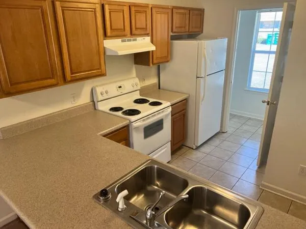 a kitchen with a stove and a refrigerator