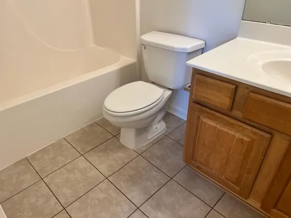 a white toilet sitting next to a bathroom sink