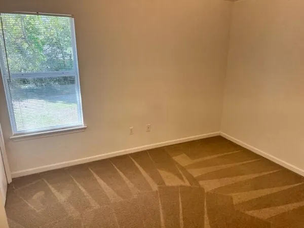 a view of a room with a window and a ceiling fan