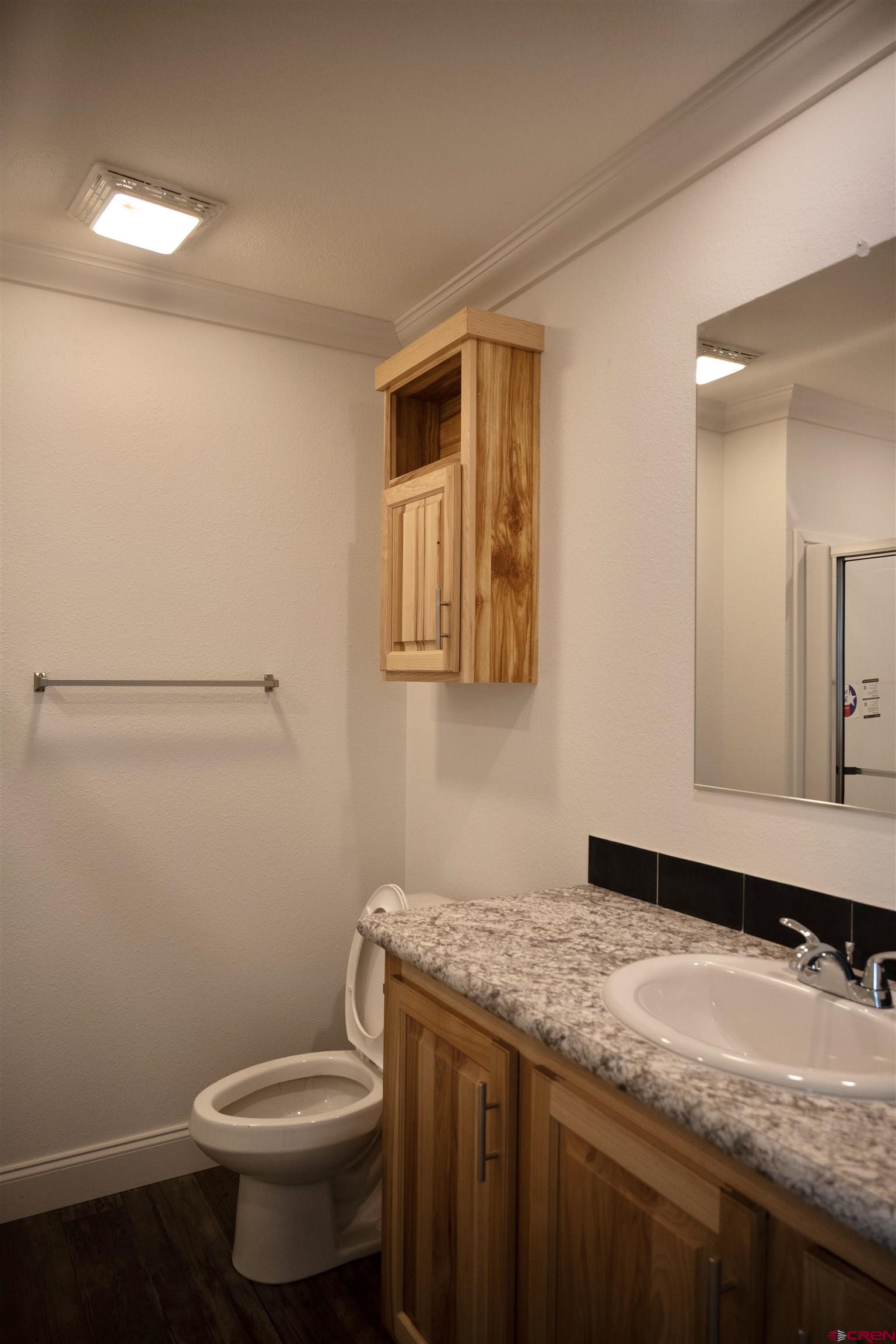 6000 County Road 203, Unit 44 Durango, CO 81301 - Photo 14 of 21 a bathroom with a granite countertop sink a toilet and mirror