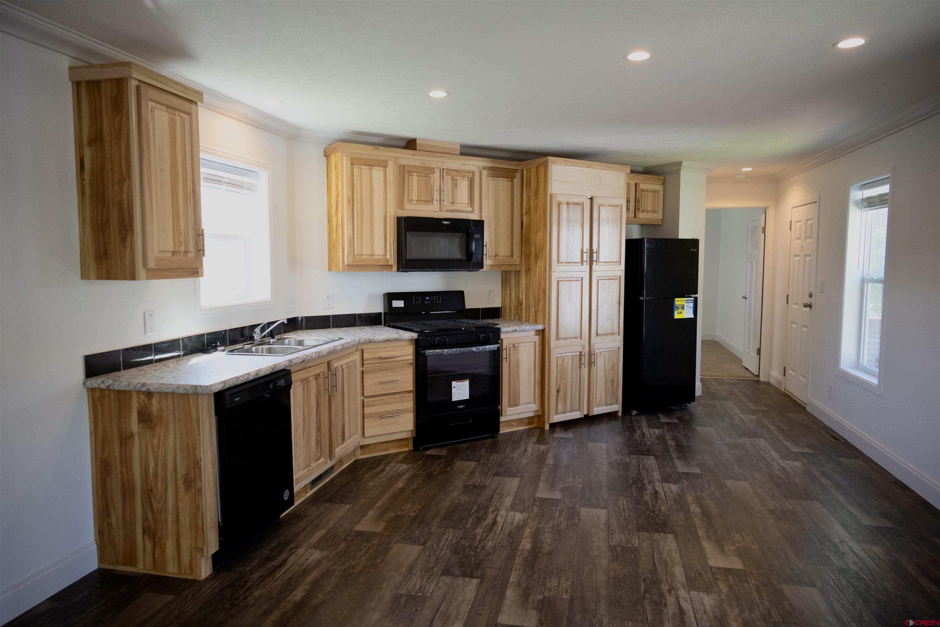6000 County Road 203, Unit 44 Durango, CO 81301 - Photo 5 of 21 a large kitchen with stainless steel appliances granite countertop a stove a sink and a refrigerator