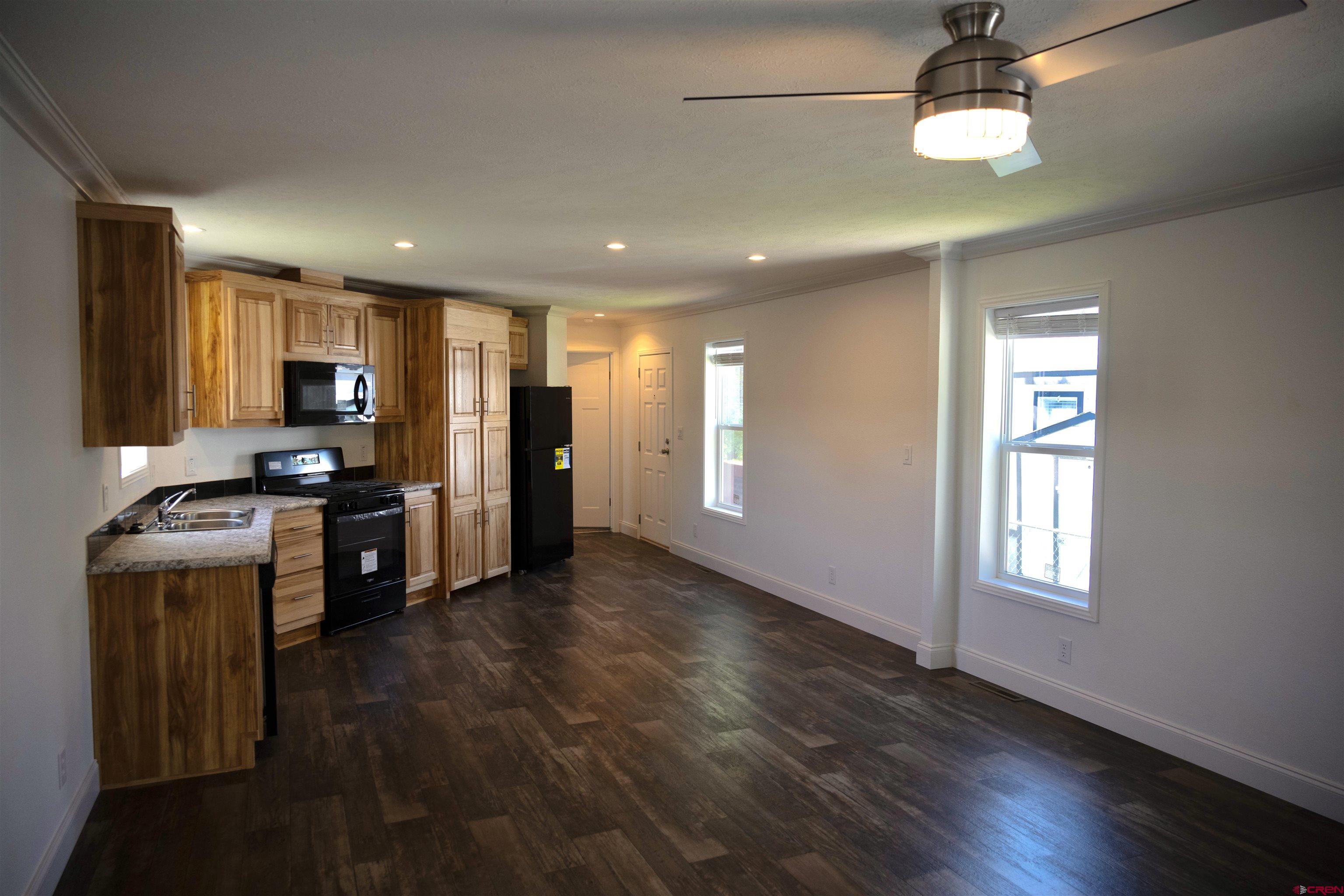 6000 County Road 203, Unit 44 Durango, CO 81301 - Photo 6 of 21 a kitchen with stainless steel appliances granite countertop a stove cabinets and wooden floor