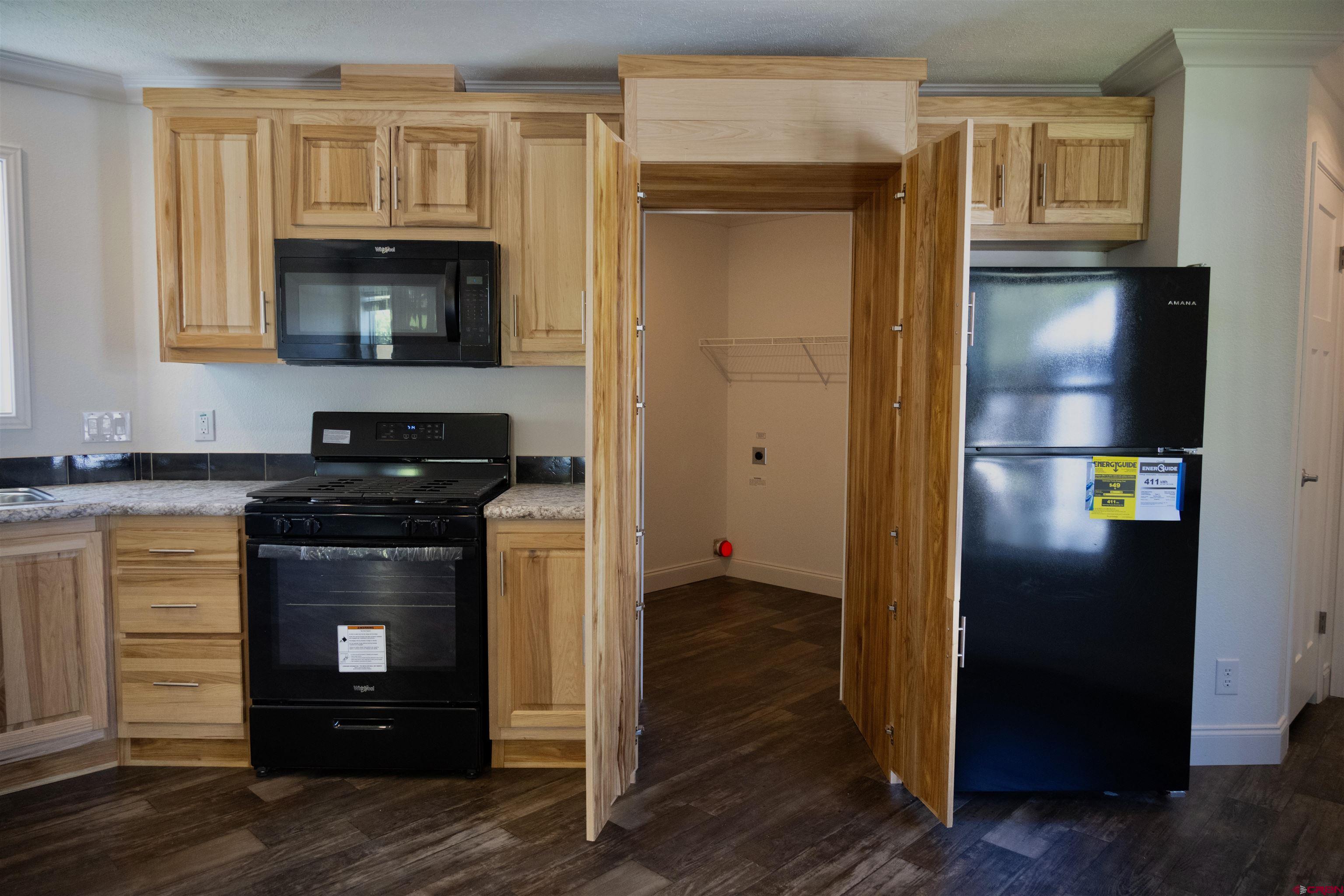 6000 County Road 203, Unit 44 Durango, CO 81301 - Photo 7 of 21 a kitchen with a refrigerator and a stove top oven
