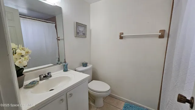 a bathroom with a sink and mirror with toilet