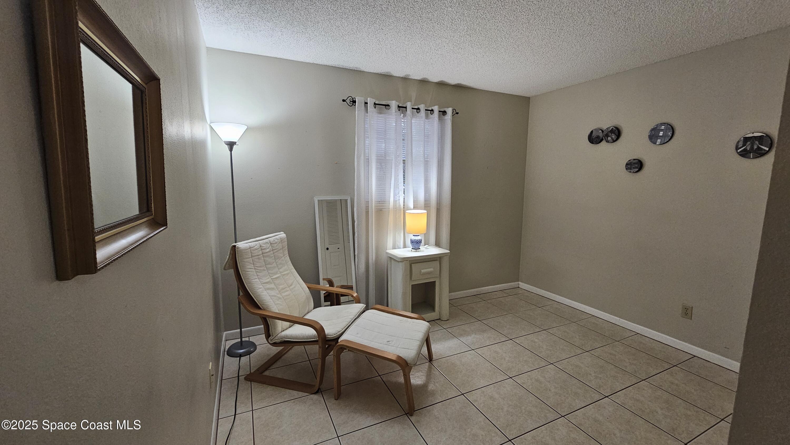 1641 Sunny Brook Lane, Unit C201 Palm Bay, FL 32905 - Photo 12 of 19 a view of a livingroom with chair and furniture