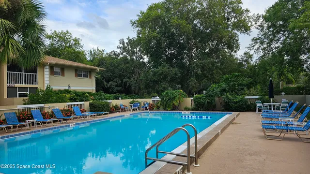 a view of a swimming pool with chairs