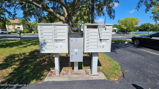 a view of a street with potted plants