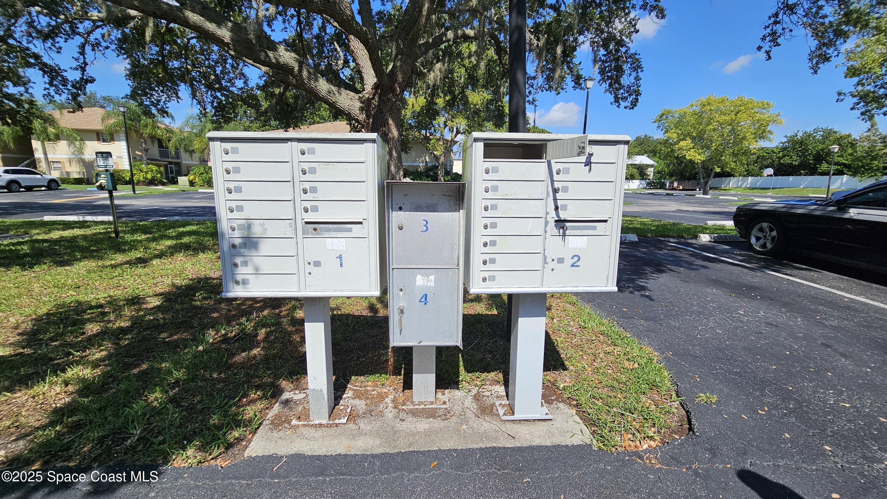 1641 Sunny Brook Lane, Unit C201 Palm Bay, FL 32905 - Photo 19 of 19 a view of a street with potted plants