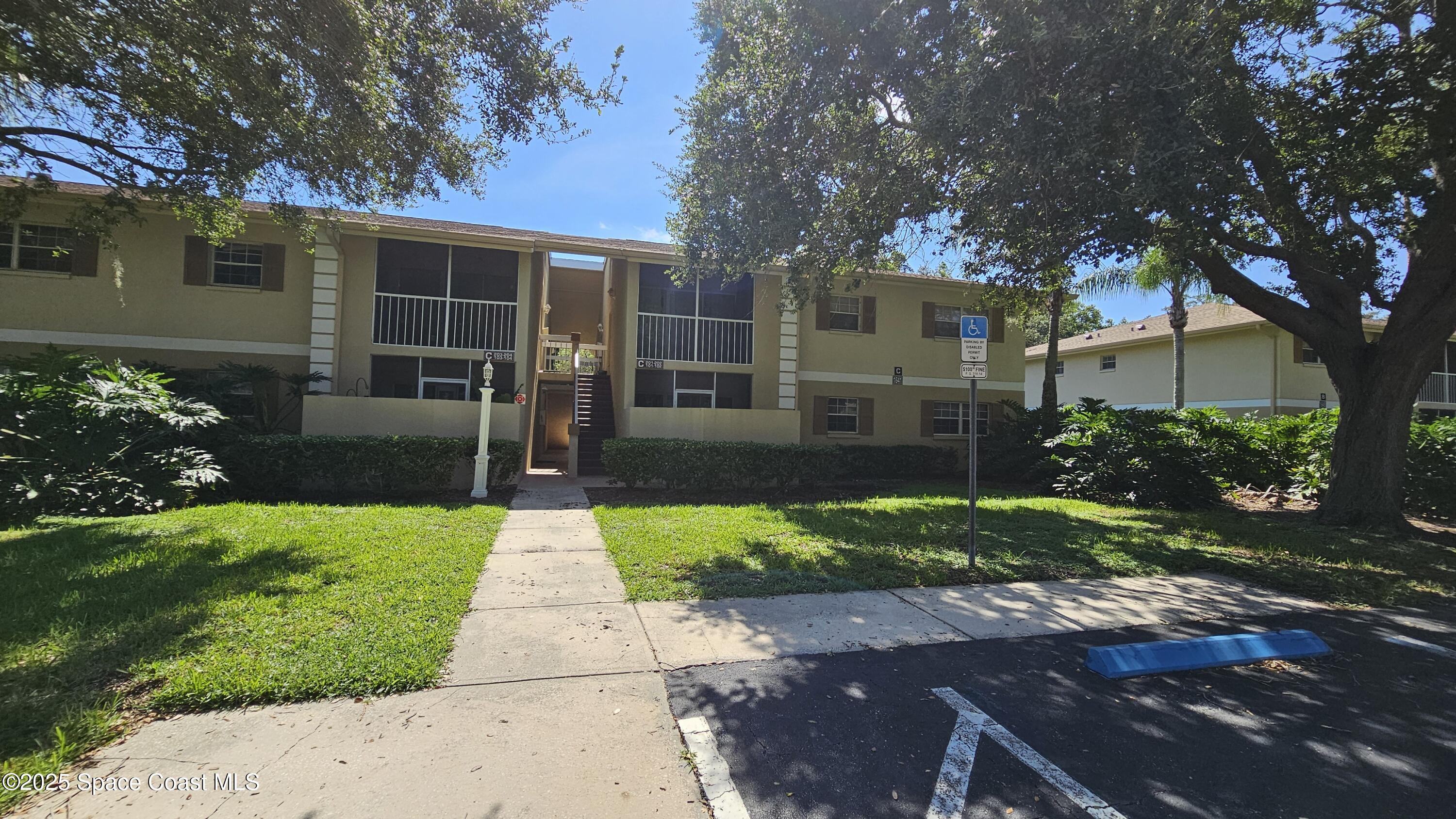 1641 Sunny Brook Lane, Unit C201 Palm Bay, FL 32905 - Photo 2 of 19 a front view of a house with garden