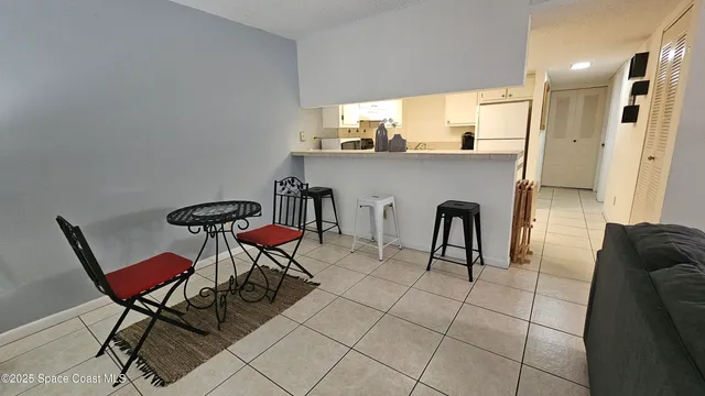 a living room with furniture and a dining table